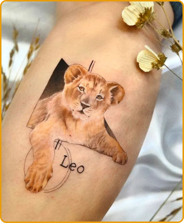 Tatuagem de leão pequeno com nome escrito em baixo